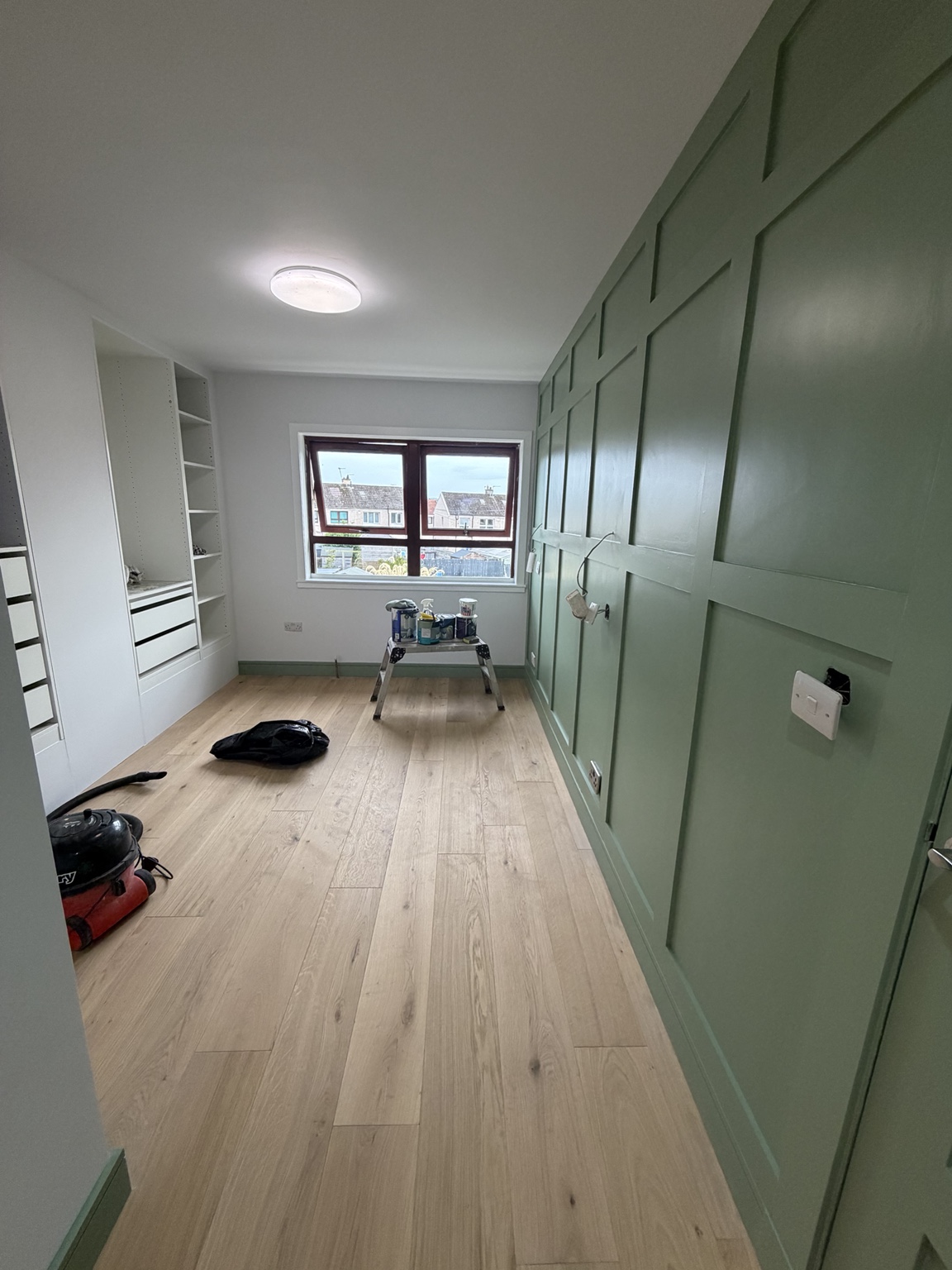 Fitted wardrobes with panelled feature wall